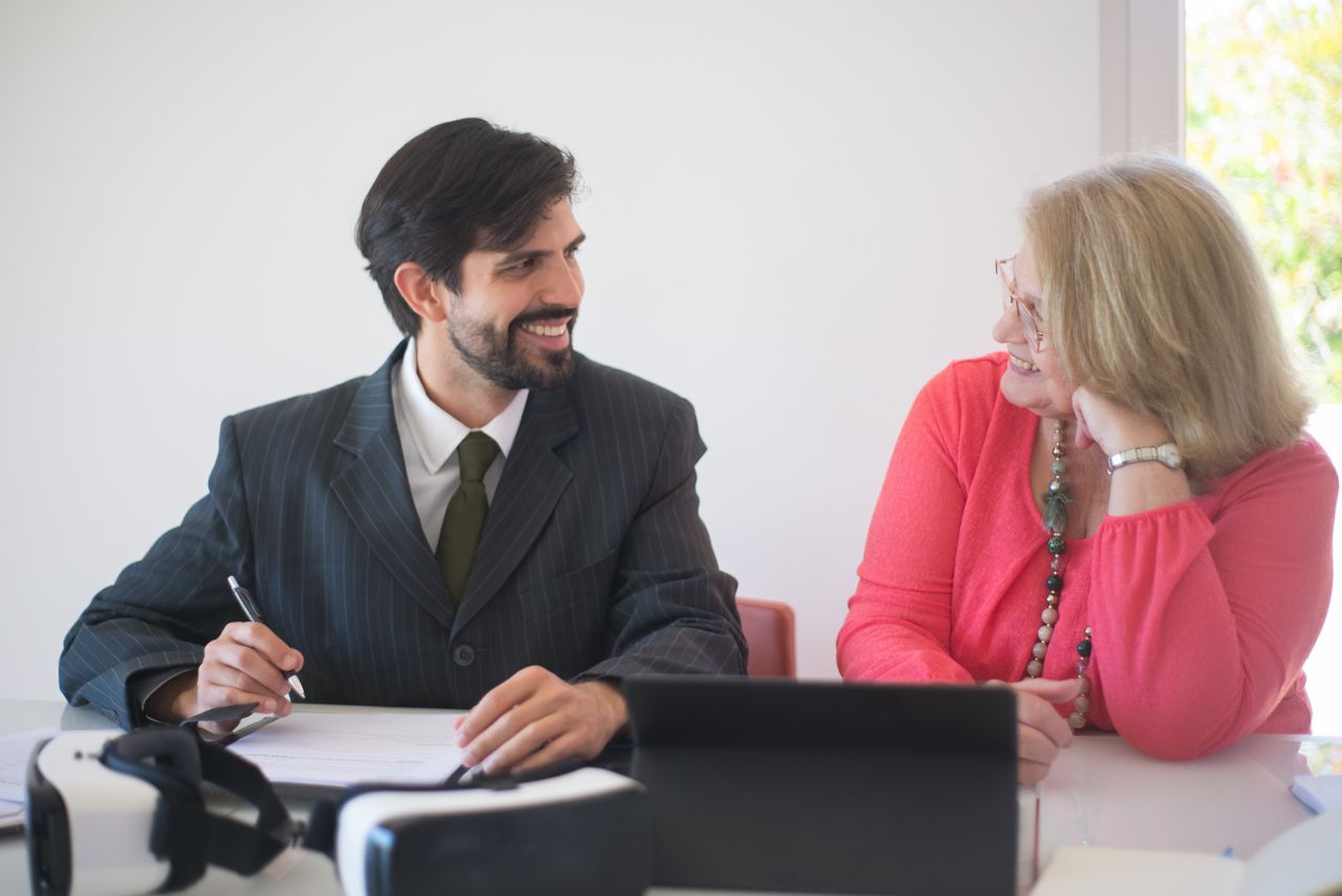 Two professionals signing a contract with joyful expressions, symbolizing a successful business deal.